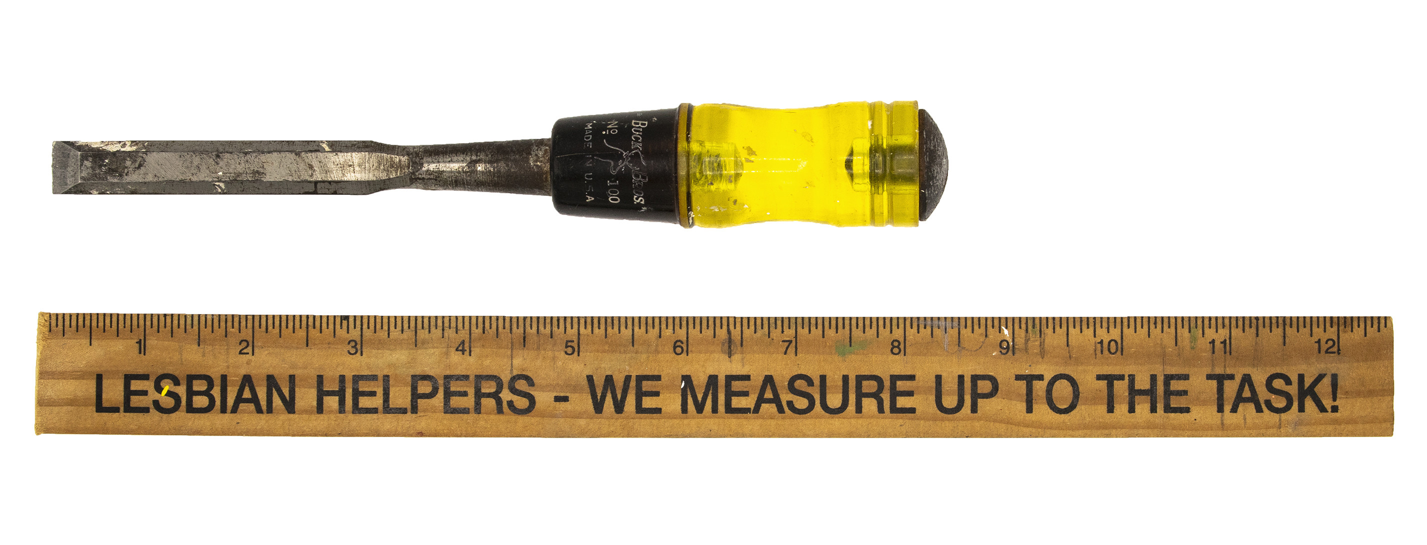 A screwdriver and ruler. The rules has the phrase 