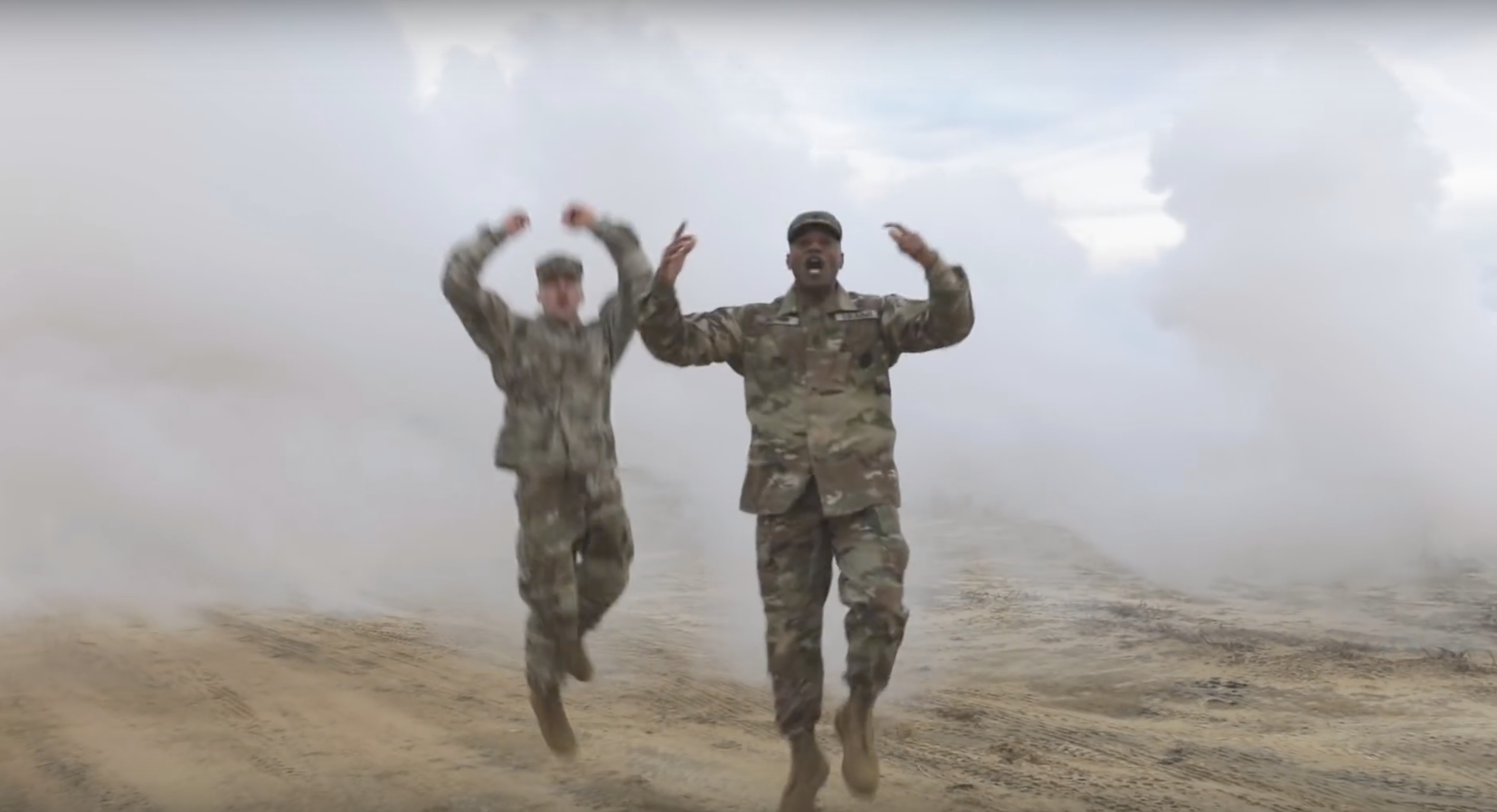 Two army men jump around in fog
