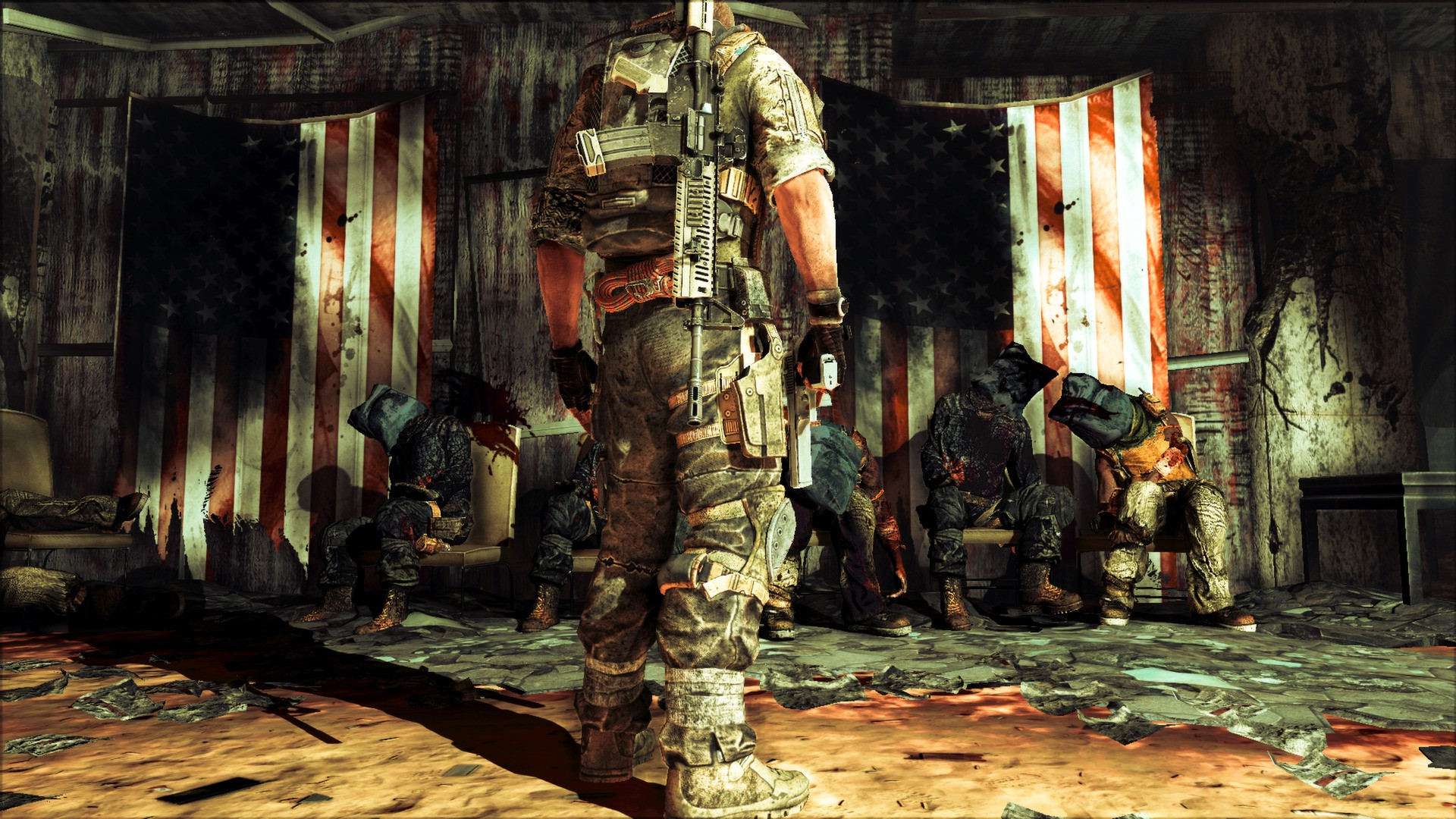 A row of black-hooded prisoners sit dead, their arms tied behind their backs to their chairs, before bloody and torn American flags in a grim scene from Spec Ops The Line
